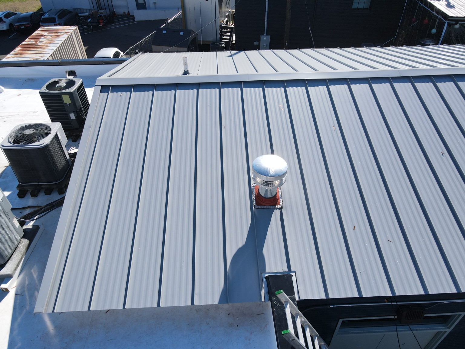 Roof exhaust penetration and ridge detail on Durham Beer Garden metal roofing