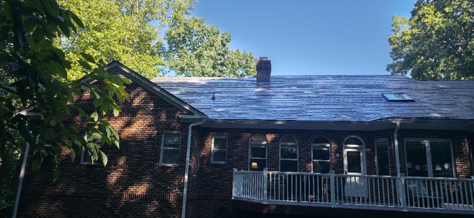 Rear roof slope with Interlock Slate metal roofing and skylight