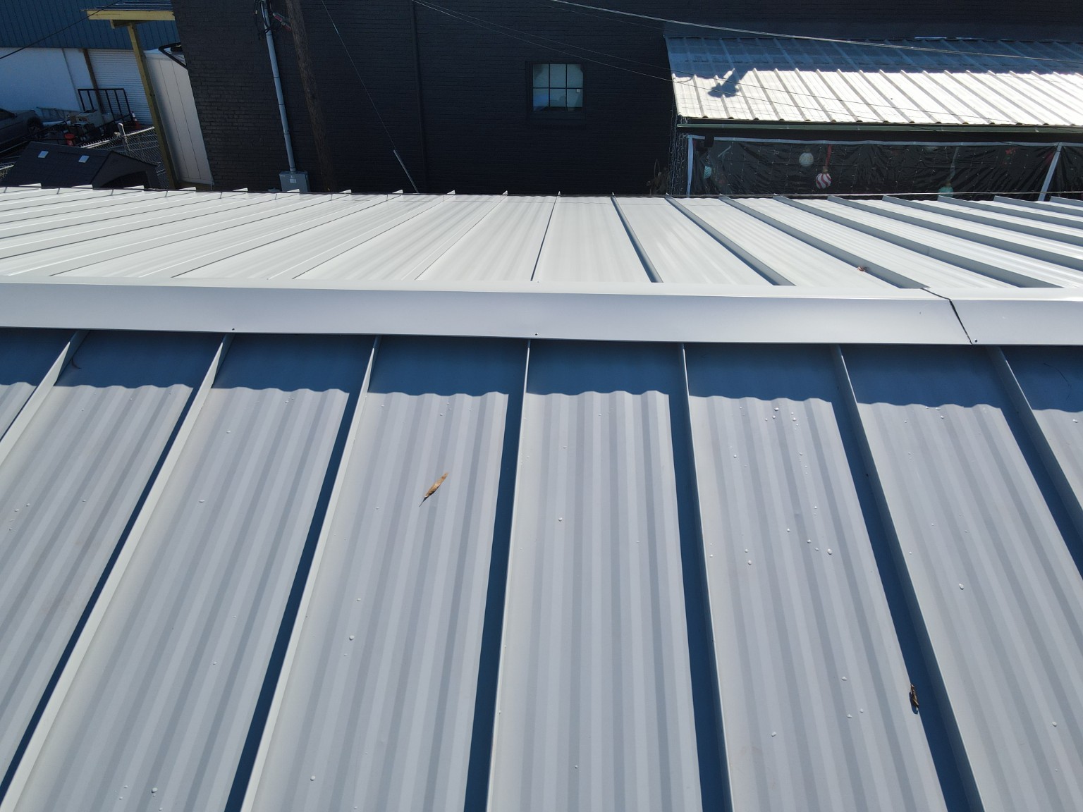 Close view of raised standing seams and ridge cap at Durham Beer Garden