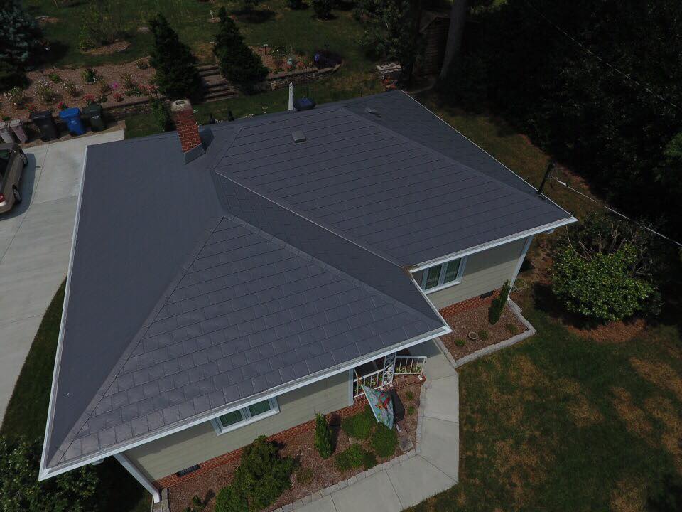 Overhead view of an Interlock Grey Slate metal hip roof and chimney in Durham, North Carolina